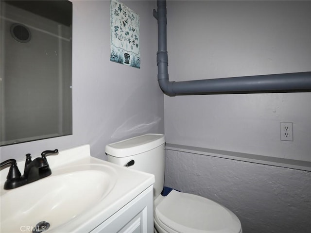 bathroom featuring toilet and vanity