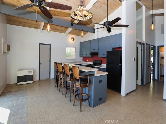 kitchen with high vaulted ceiling, black appliances, a kitchen breakfast bar, heating unit, and light countertops