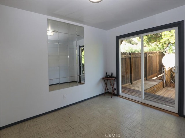 unfurnished room featuring tile patterned floors and baseboards