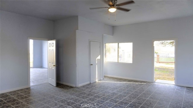 spare room with tile patterned floors, baseboards, and ceiling fan