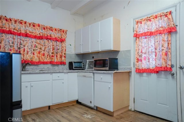 kitchen with stainless steel microwave, fridge, white dishwasher, and light wood-type flooring