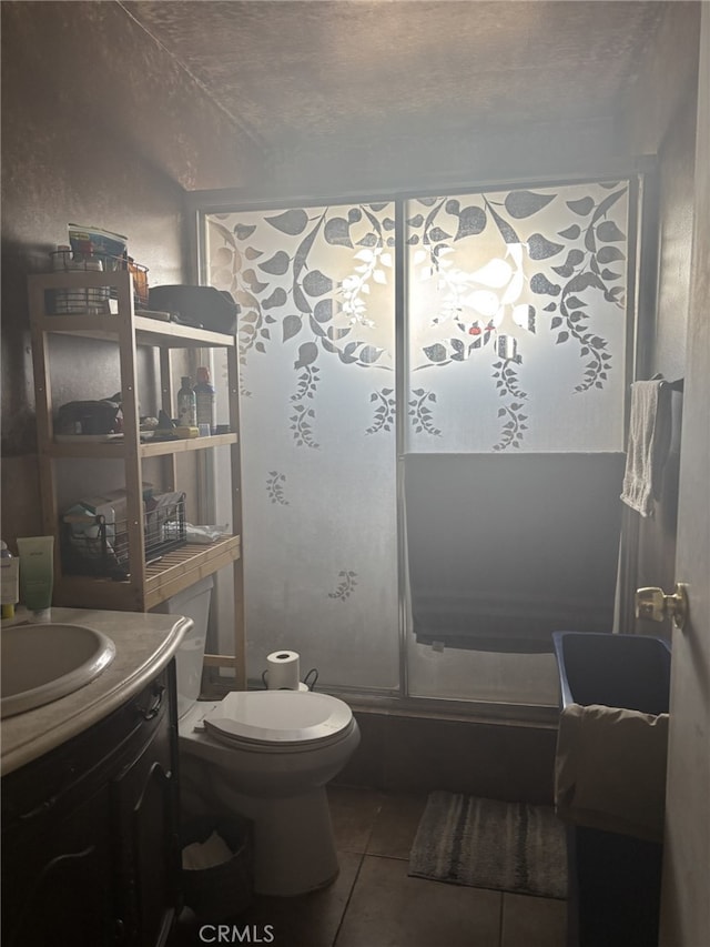 bathroom with tile patterned floors, toilet, and vanity