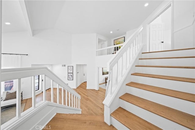 stairway featuring recessed lighting and wood finished floors