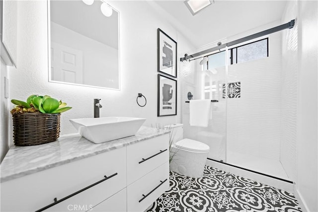 bathroom with toilet, a stall shower, vanity, and tile patterned flooring