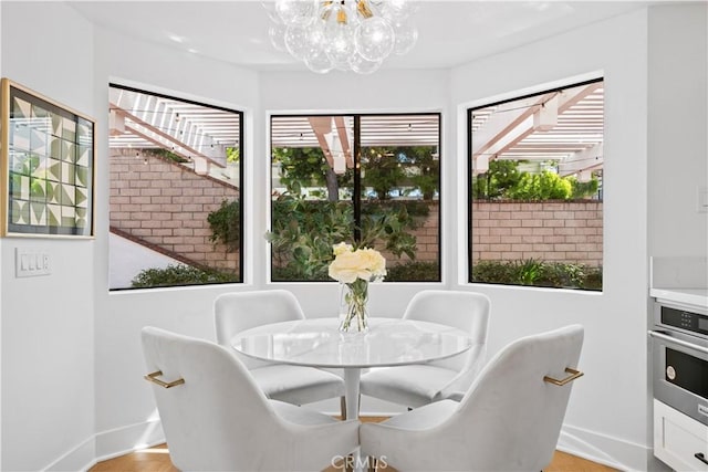 dining room with baseboards and an inviting chandelier