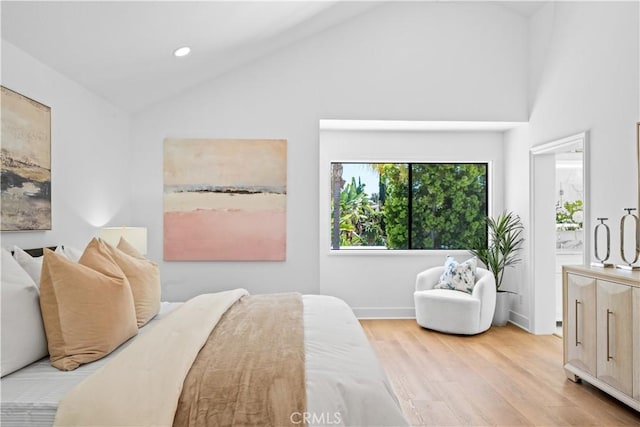 bedroom with recessed lighting, baseboards, light wood-type flooring, and lofted ceiling