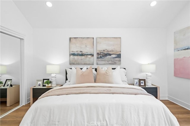 bedroom featuring recessed lighting, baseboards, wood finished floors, and vaulted ceiling