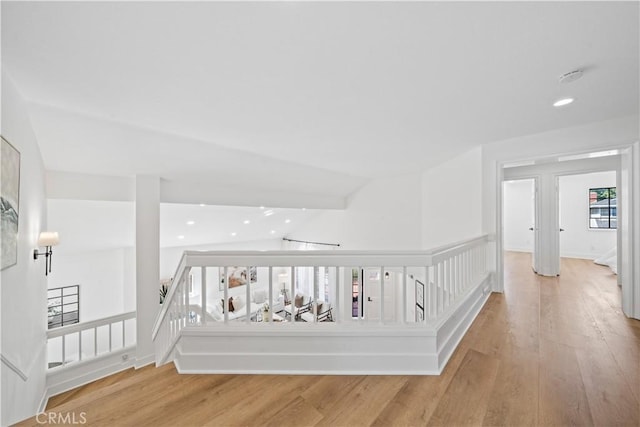 corridor featuring recessed lighting, light wood-type flooring, and vaulted ceiling