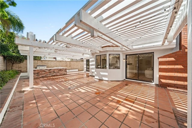 view of patio / terrace with a pergola and fence