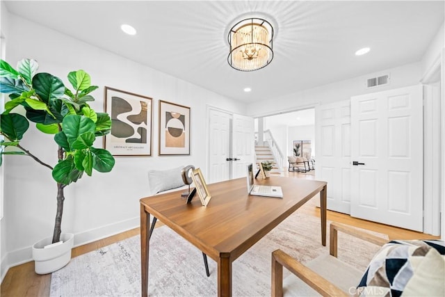 office space featuring recessed lighting, visible vents, light wood finished floors, and baseboards