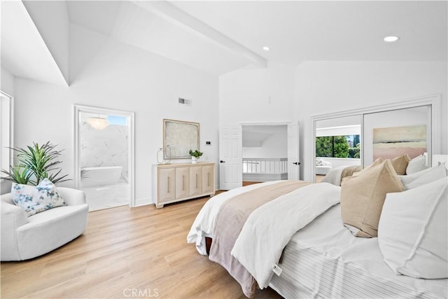 bedroom featuring visible vents, beamed ceiling, light wood-style flooring, recessed lighting, and connected bathroom