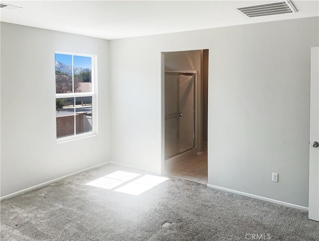 unfurnished bedroom with visible vents, baseboards, and carpet flooring