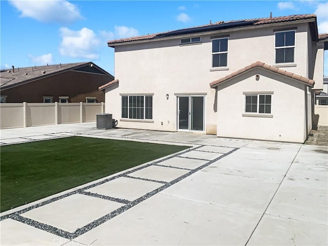 back of property featuring a patio area, stucco siding, a yard, and fence