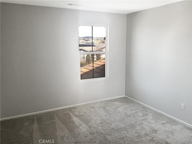 unfurnished room featuring visible vents, carpet flooring, and baseboards