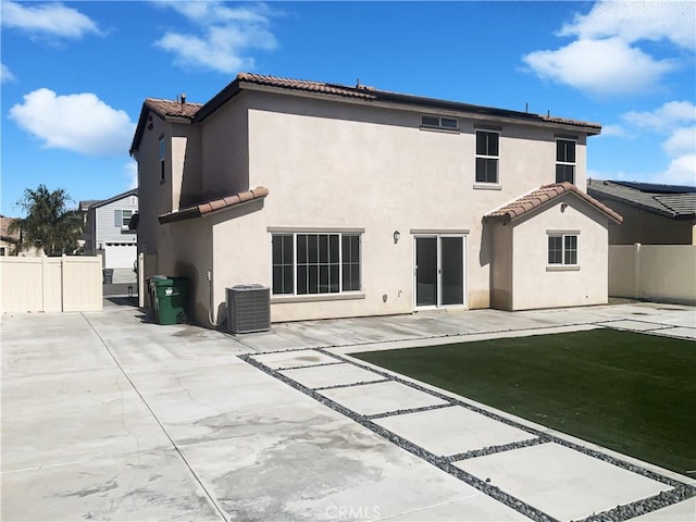 back of house with stucco siding, central air condition unit, a patio area, and fence