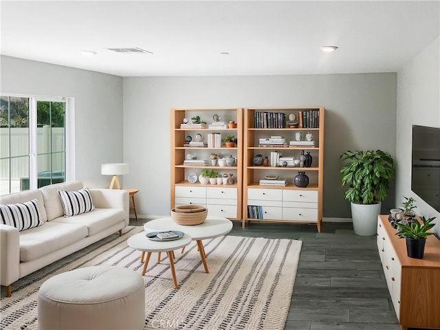 living area featuring dark wood finished floors, baseboards, and visible vents