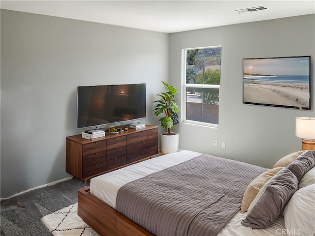 bedroom featuring visible vents, baseboards, and carpet floors