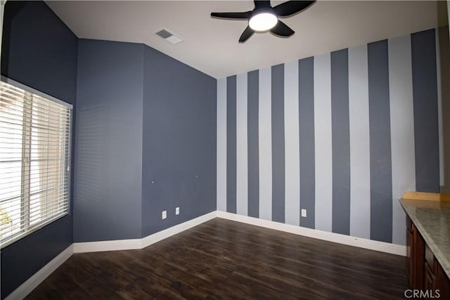 unfurnished room featuring visible vents, baseboards, and wallpapered walls