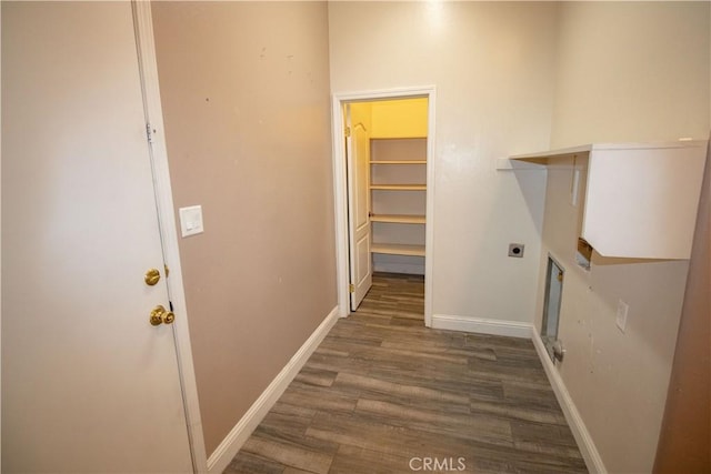 laundry room featuring laundry area, wood finished floors, baseboards, and electric dryer hookup