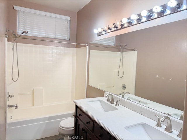 bathroom with toilet, shower / bathtub combination, and a sink