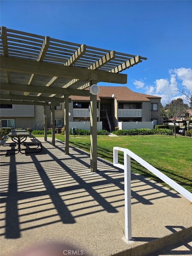 view of home's community with a lawn and a pergola