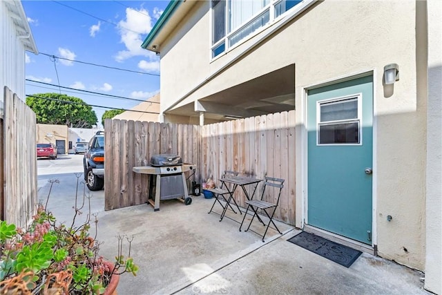 view of patio with fence and grilling area