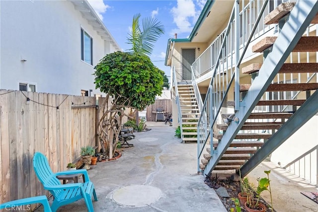 view of patio / terrace with stairs and a fenced backyard