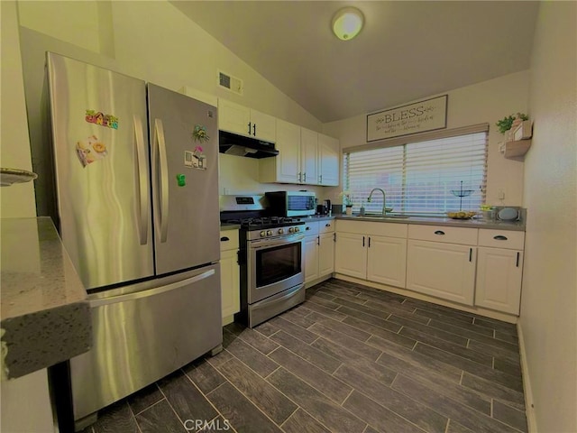 kitchen with under cabinet range hood, stainless steel appliances, visible vents, and white cabinetry