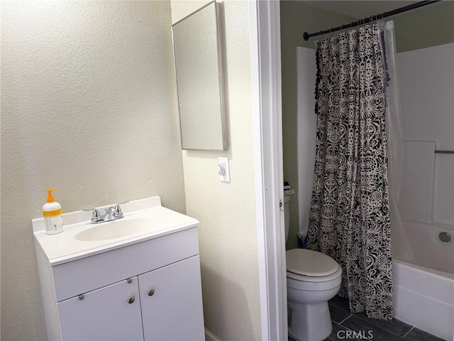 full bath with vanity, shower / bath combination with curtain, toilet, and a textured wall