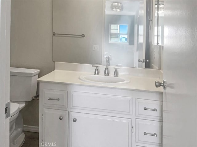 half bathroom with toilet and vanity