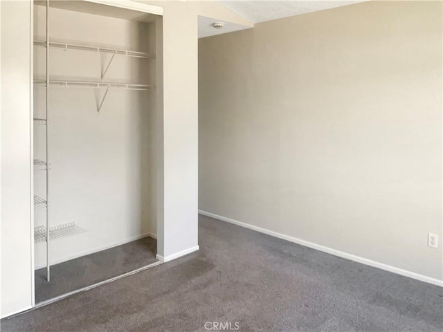 unfurnished bedroom featuring a closet, baseboards, and carpet