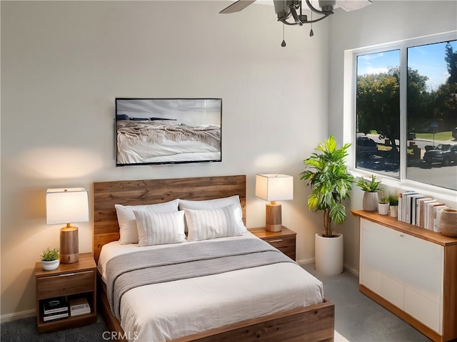 carpeted bedroom featuring baseboards and ceiling fan