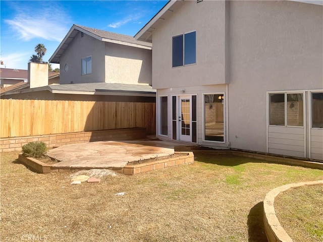 back of property featuring a patio area, stucco siding, and fence