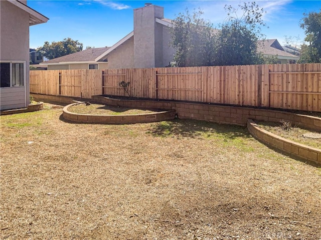 view of yard with a fenced backyard