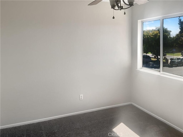 spare room with baseboards and ceiling fan