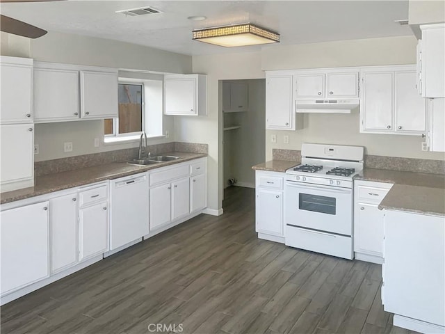 kitchen with visible vents, a sink, dark wood finished floors, white appliances, and white cabinets