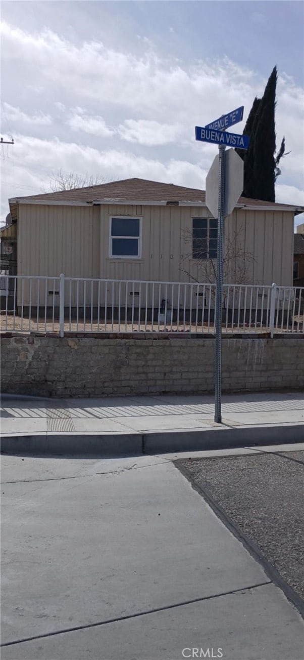 view of front of house featuring fence