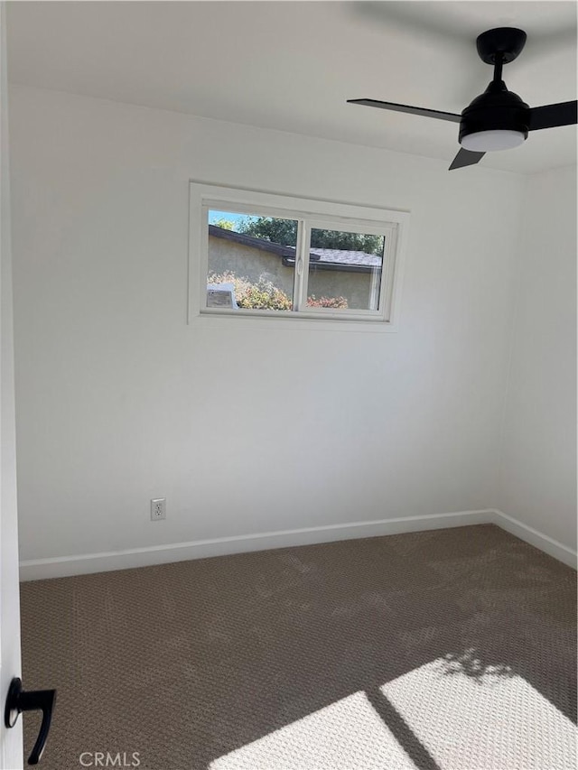 unfurnished room with carpet flooring, baseboards, and ceiling fan