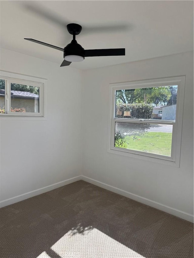 spare room featuring a ceiling fan, baseboards, and carpet floors