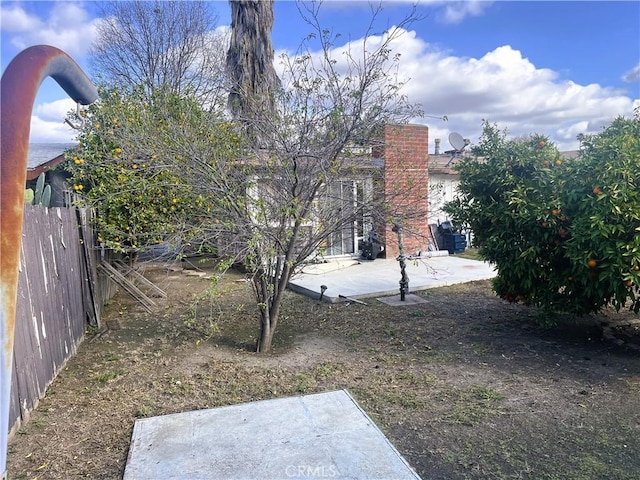 view of yard featuring a patio and fence