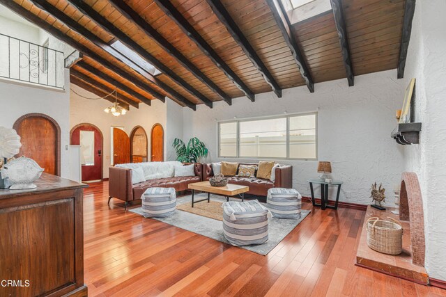 5451 Reef Way, Oxnard, CA 93035 - living room with wood ceiling, hardwood / wood-style flooring, a textured wall, arched walkways, and a chandelier
