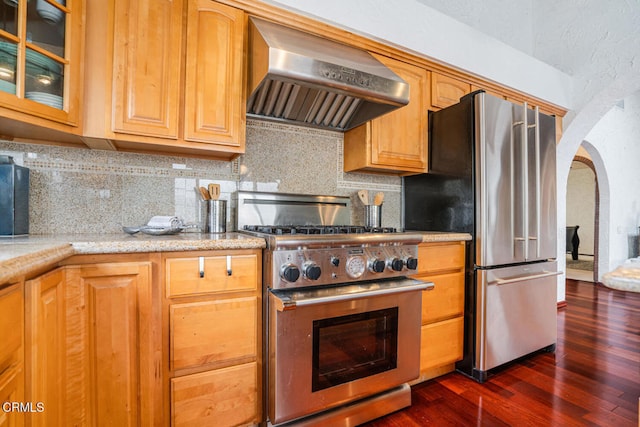 5451 Reef Way, Oxnard, CA 93035 - kitchen with stainless steel appliances, ventilation hood, arched walkways, dark wood-type flooring, and backsplash
