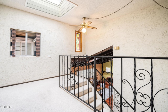 5451 Reef Way, Oxnard, CA 93035 - stairway with carpet floors, a textured wall, a skylight, ceiling fan, and a textured ceiling