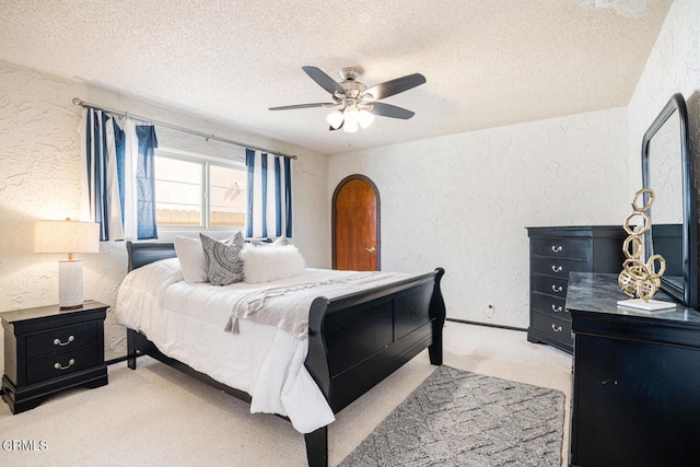 5451 Reef Way, Oxnard, CA 93035 - carpeted bedroom featuring a textured wall, a textured ceiling, a ceiling fan, and arched walkways