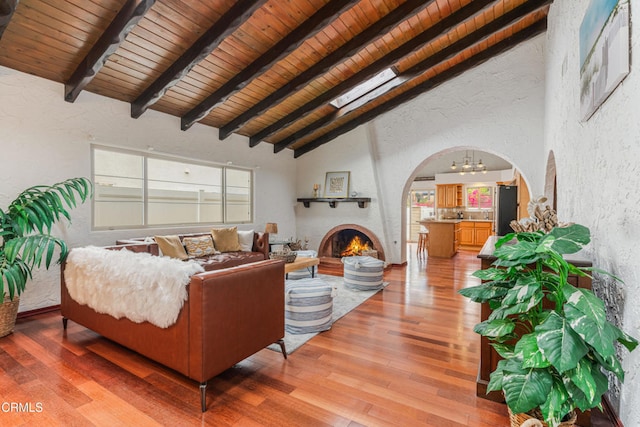 5451 Reef Way, Oxnard, CA 93035 - living room with a textured wall, wood ceiling, arched walkways, light wood-style flooring, and a chandelier