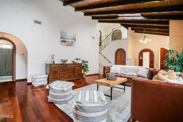 5451 Reef Way, Oxnard, CA 93035 - living room with arched walkways, dark wood-type flooring, a chandelier, and a textured wall
