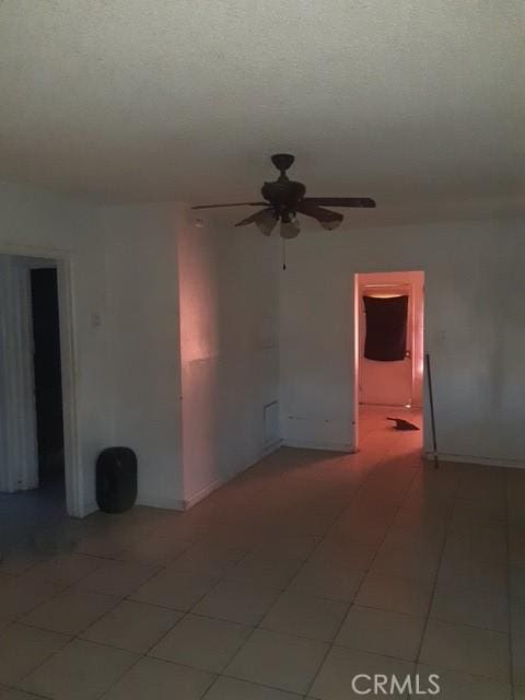 spare room with a ceiling fan and a textured ceiling