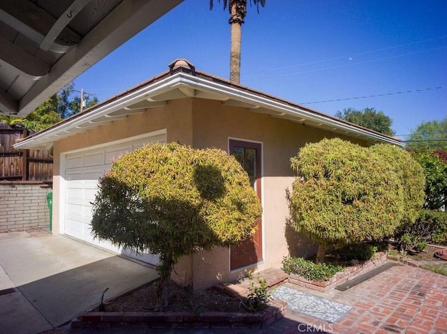 view of home's exterior featuring stucco siding and an attached garage