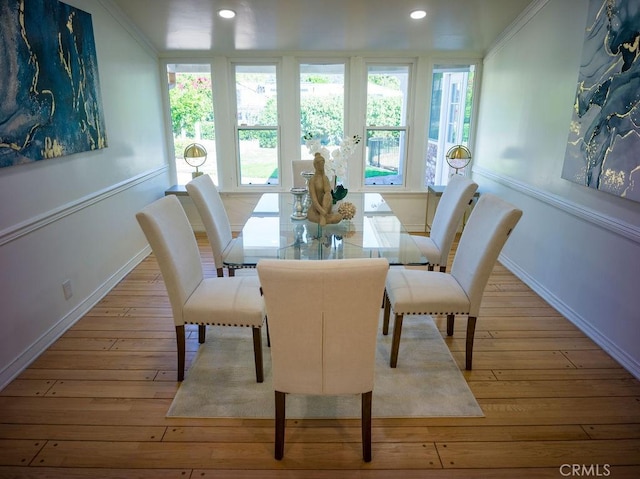 dining room featuring recessed lighting, wood-type flooring, and a healthy amount of sunlight