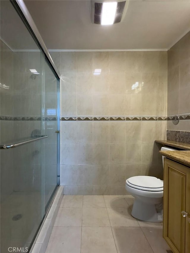 full bath with tile patterned floors, a stall shower, tile walls, and vanity